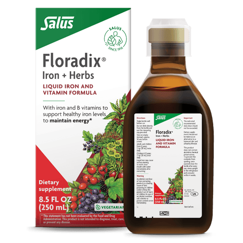 Salus Floradix Iron + Herbs liquid supplement bottle and packaging box, featuring a white and green design with red accents and an illustration of fresh herbs and fruits.